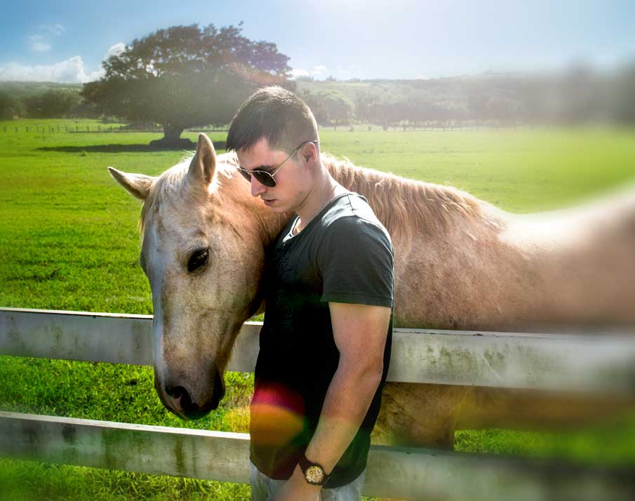 Boy with sunglasses and horse